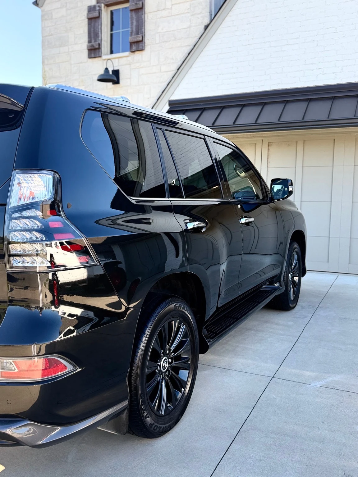 Glossy black Lexus SUV viewed from the rear side